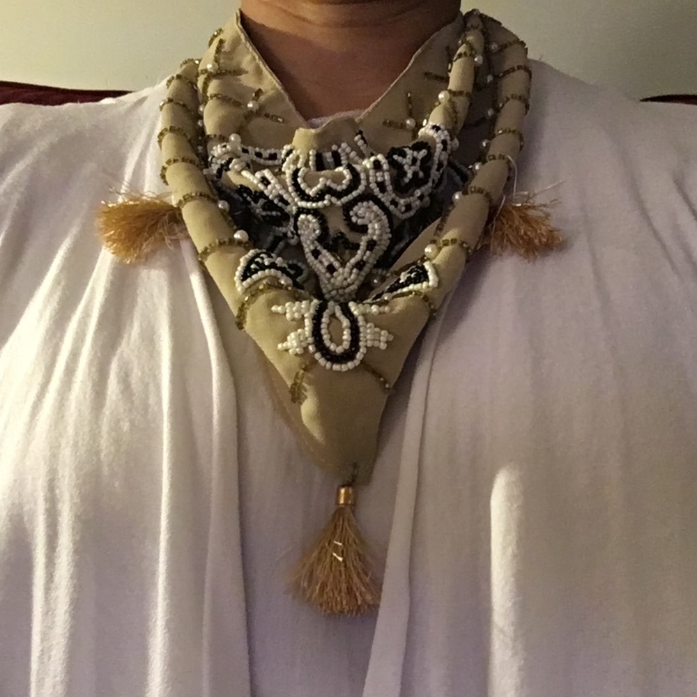 Beige scarf with faux pearl and black beads.